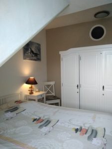 Chambre parentale avec grand lit et armoire